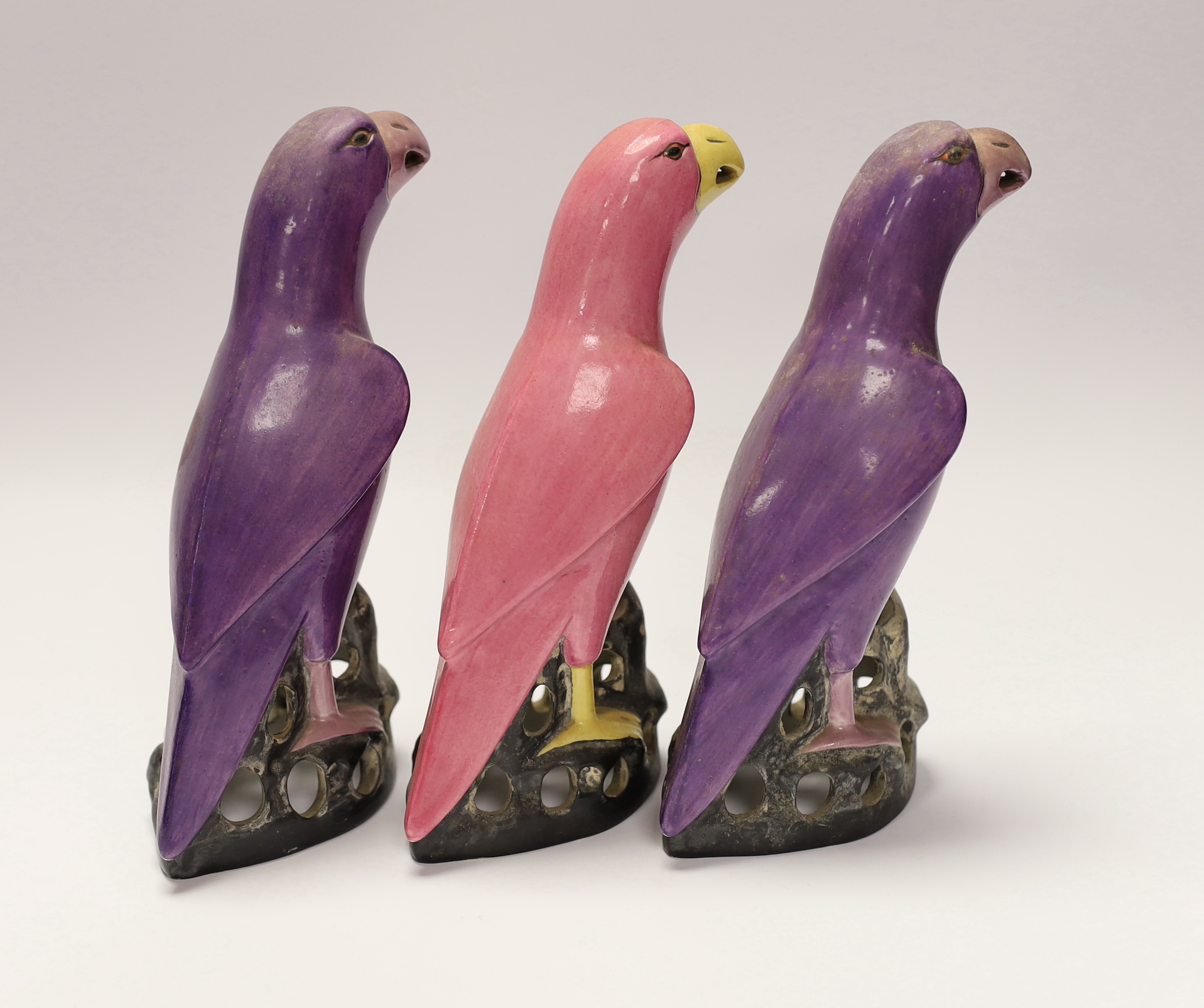 Three Crown Staffordshire parrots with purple and pink glazed, each stamped, 19cm high